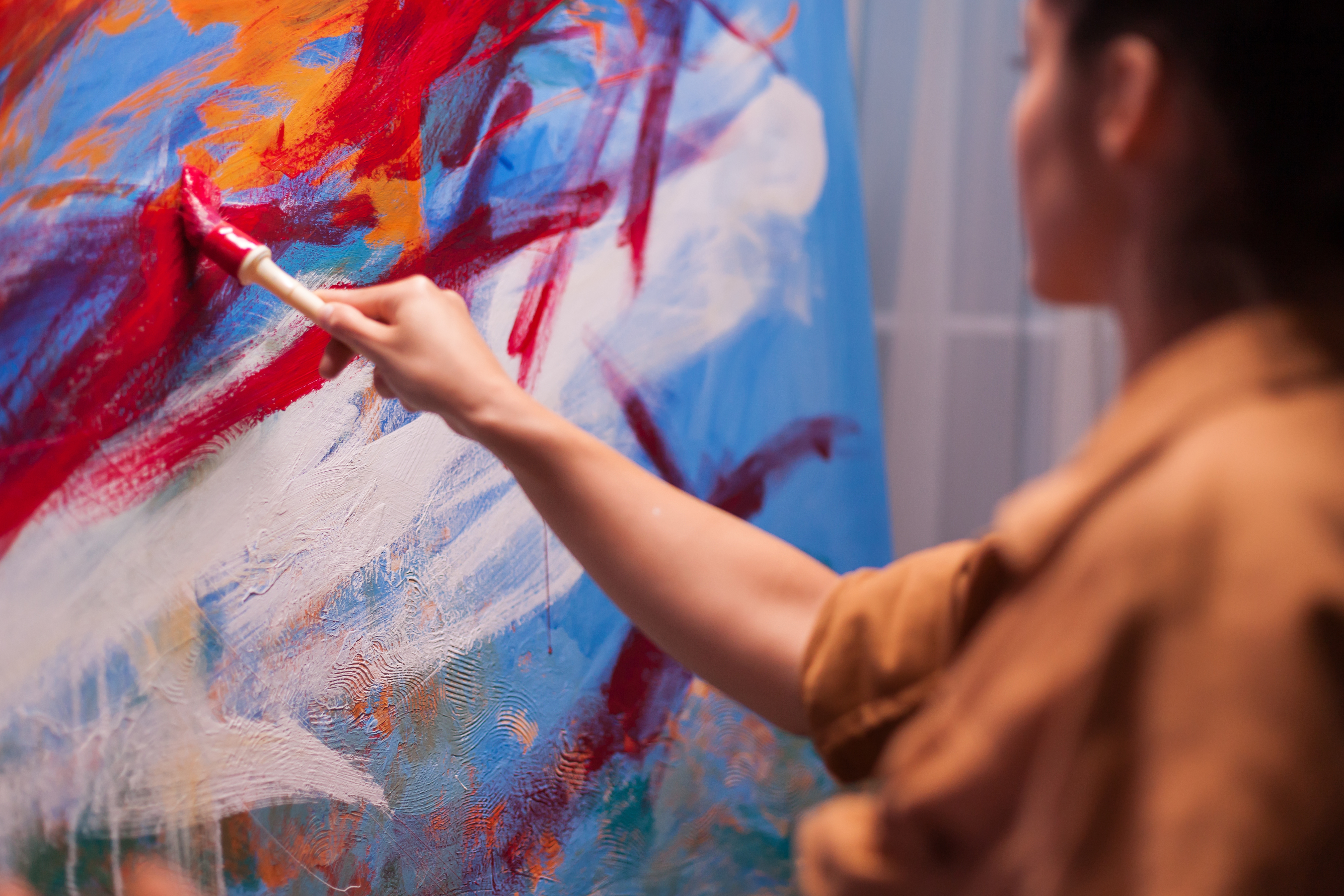 Contemporary artist working on a colorful abstract painting